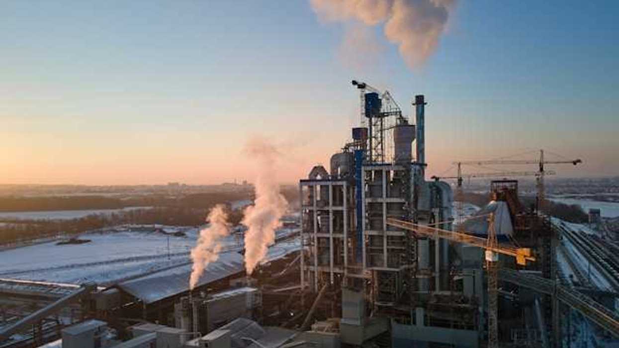 A view of an industrial plant emitting pollution into the sky