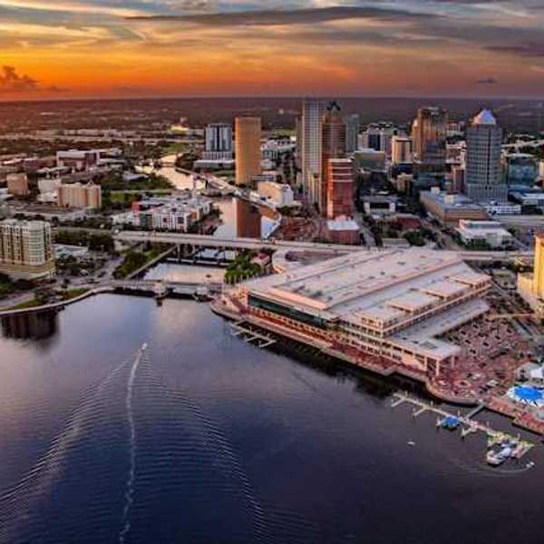 A view of downtown Tampa, Florida along the Hillsborough river against a night sky