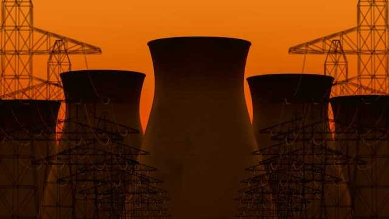 A view of nuclear towers with an orange sky in the background