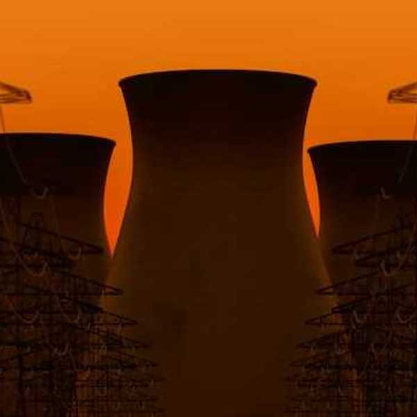A view of nuclear towers with an orange sky in the background