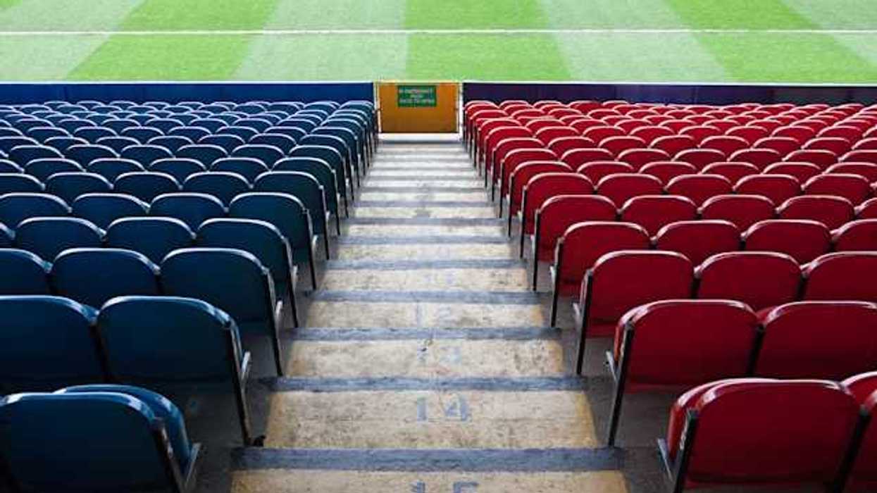 A view of stadium seats leading to a green field