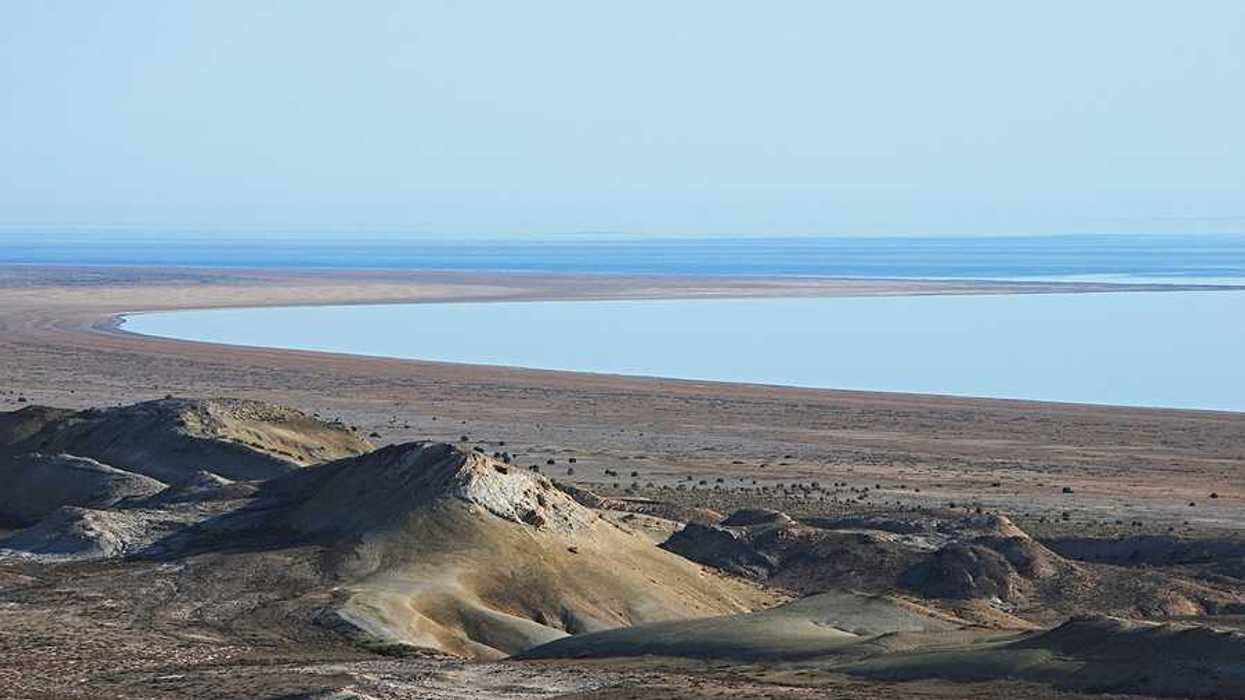 A view of the Aral Sea in Uzbekistan showing the water receding from a dry environment