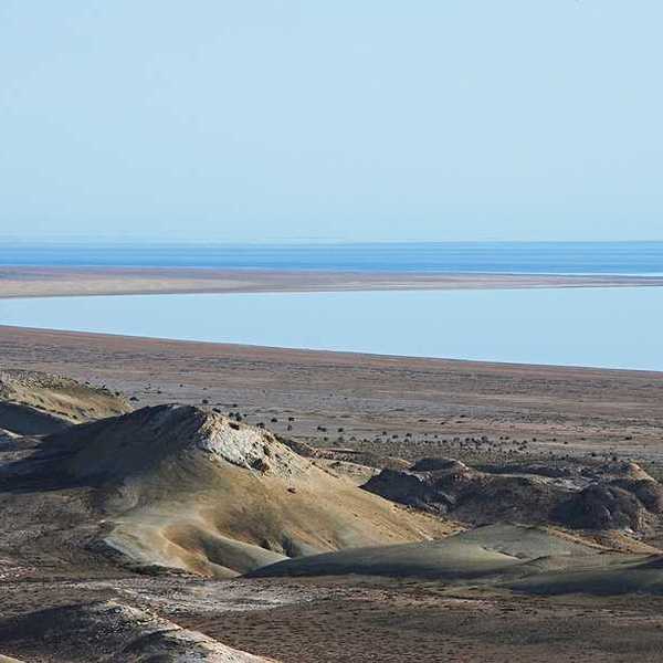 A view of the Aral Sea in Uzbekistan showing the water receding from a dry environment