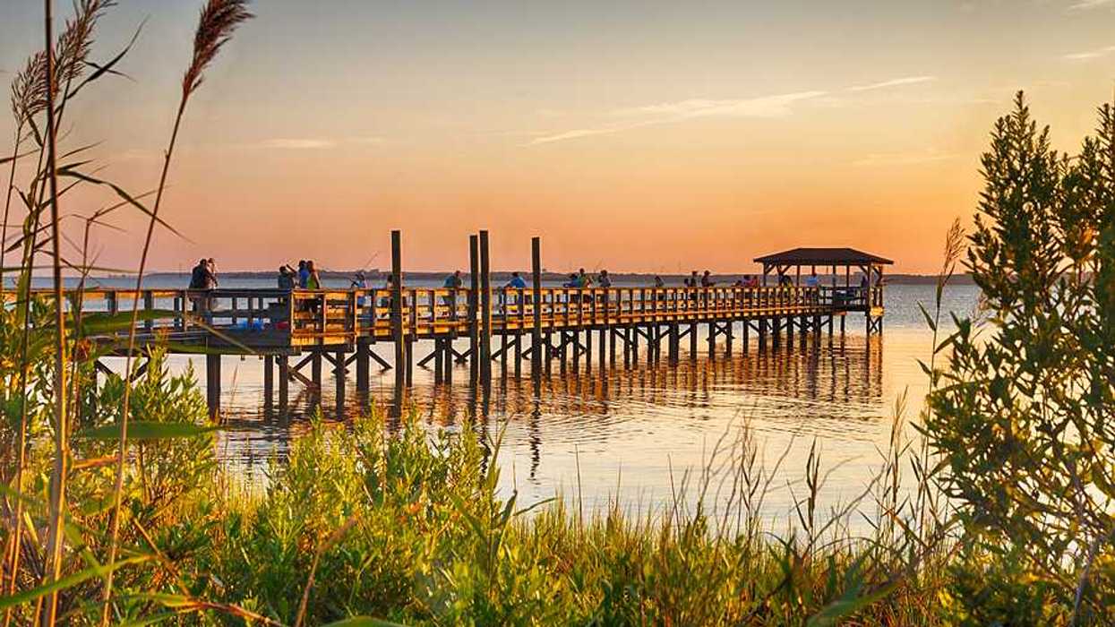 A view of the Cape Fear river with a wood dock stretching over the water
