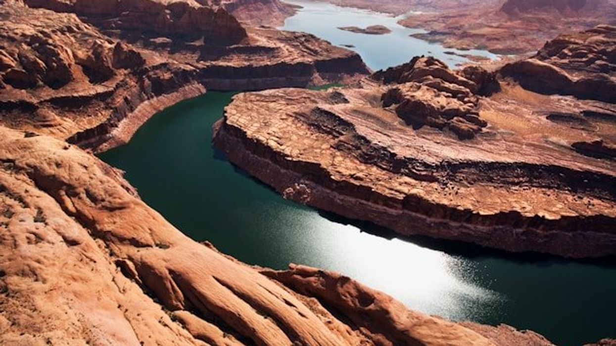 A view of the Colorado River winding through a dry rocky landscape.