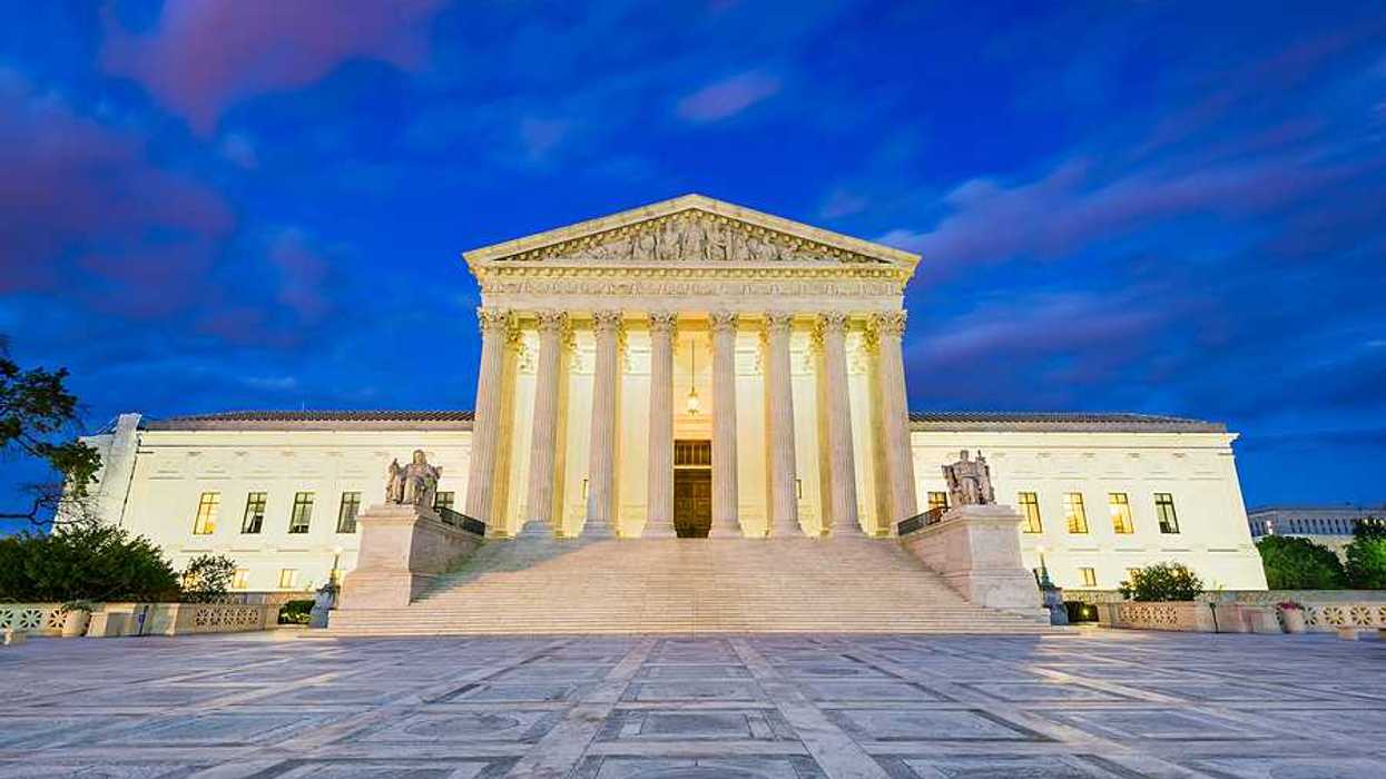 A view of the Supreme Court of the US against a dark cloudy sky