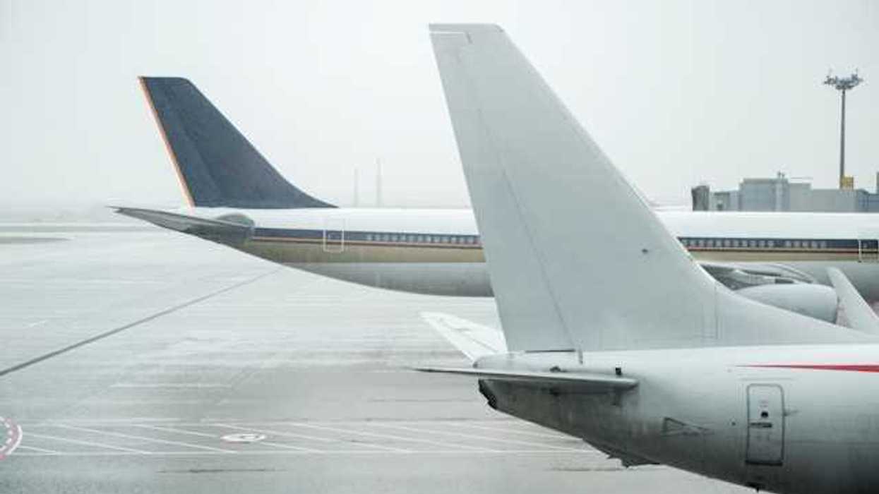A view of the tail ends of two large jets on the tarmac