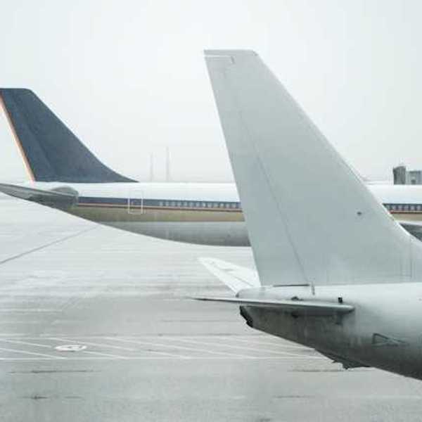 A view of the tail ends of two large jets on the tarmac