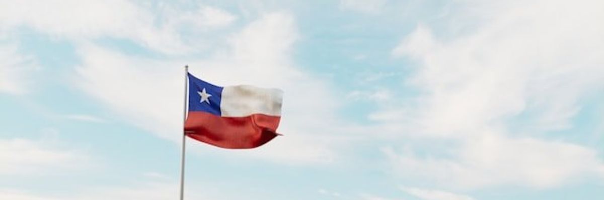 A view of the Texas flag against a cloudy sky.