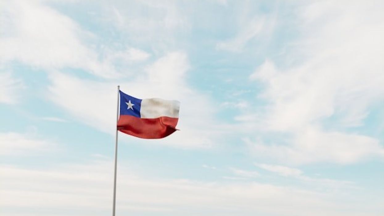 A view of the Texas flag against a cloudy sky.