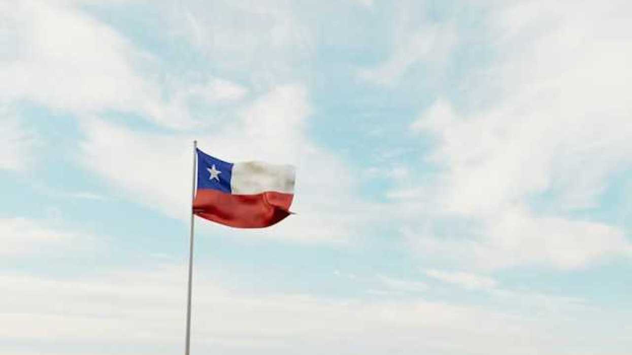 A view of the Texas flag waving against a blue sky