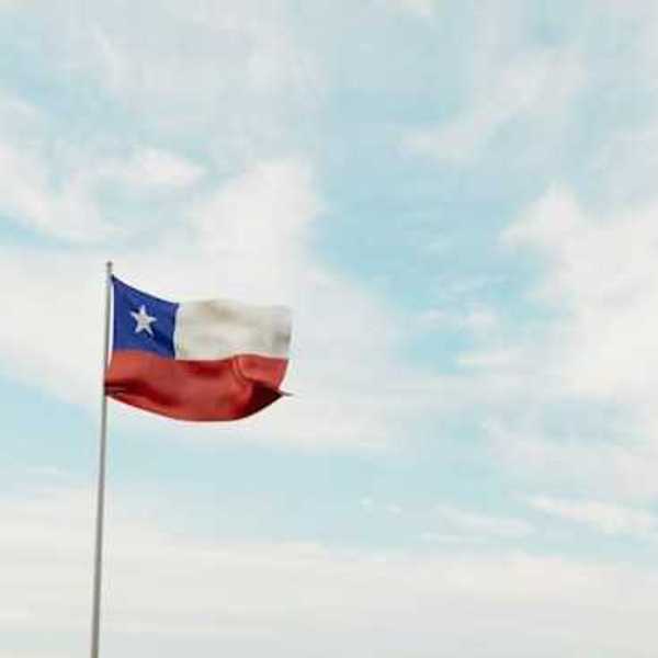 A view of the Texas flag waving against a blue sky