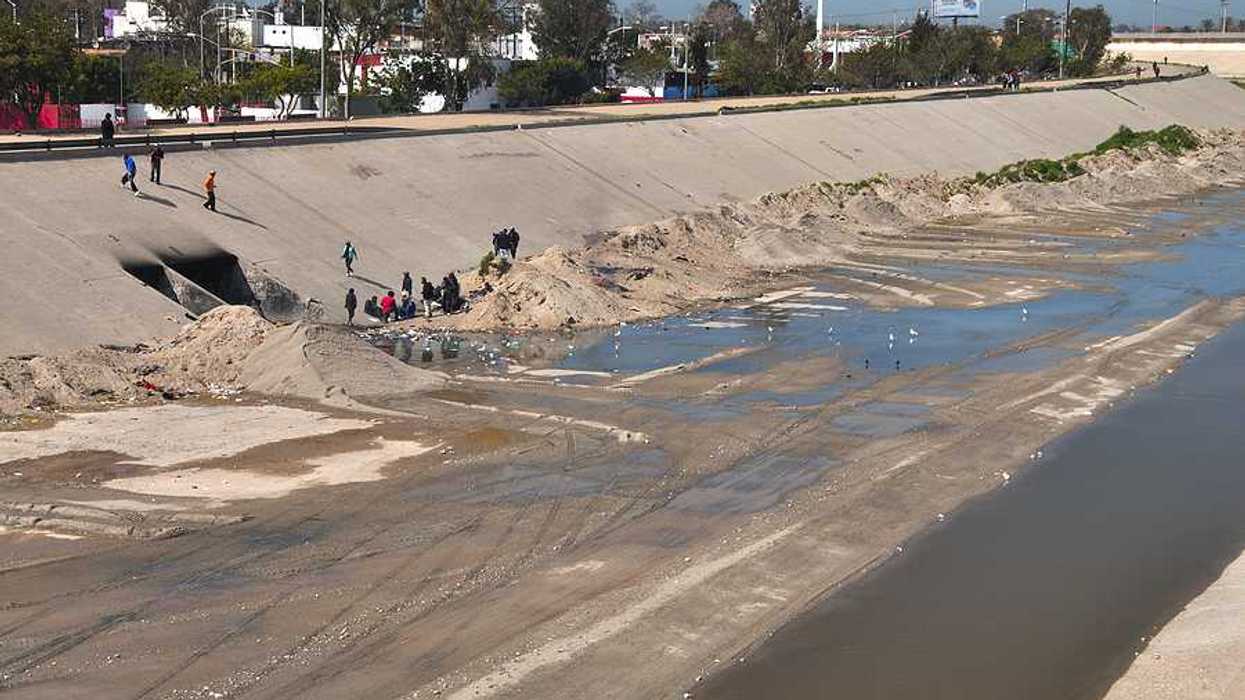 A view of the Tijuana River with water and concrete