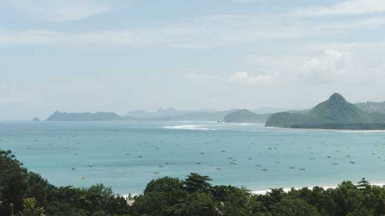 A view of turquoise water and a tropical island