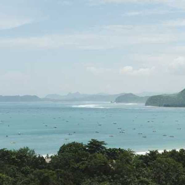 A view of turquoise water and a tropical island