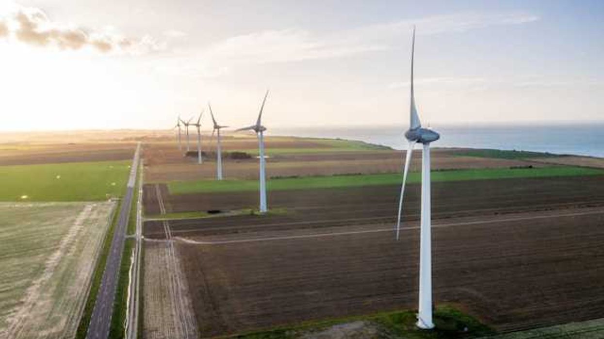 A view of wind turbines situated along the ocean