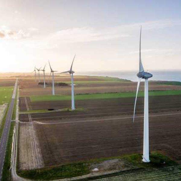 A view of wind turbines situated along the ocean