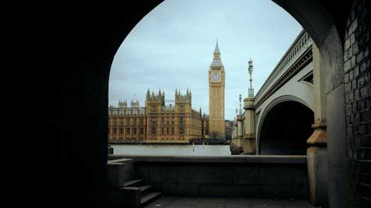 A view through an arch of Big Ben clock and the parliament building in London