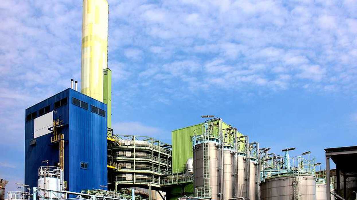 A waste incinerator facility with a blue sky in the background