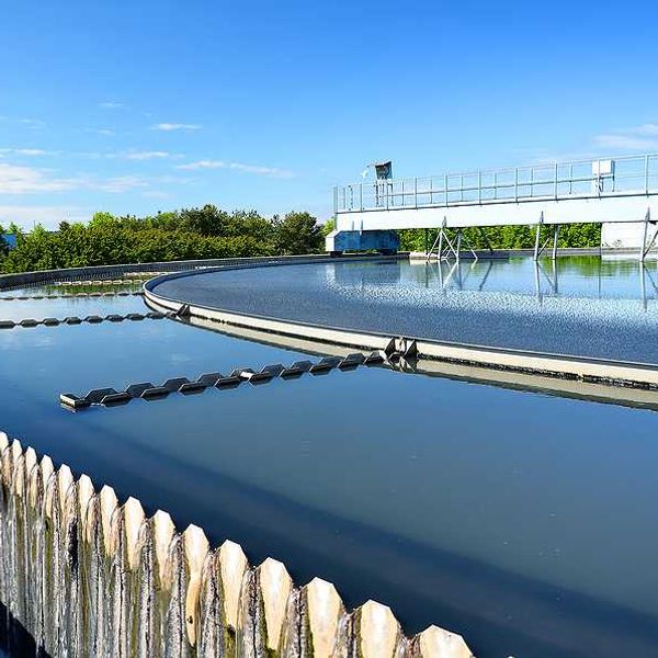 A wastewater tank filled with water on a sunny day