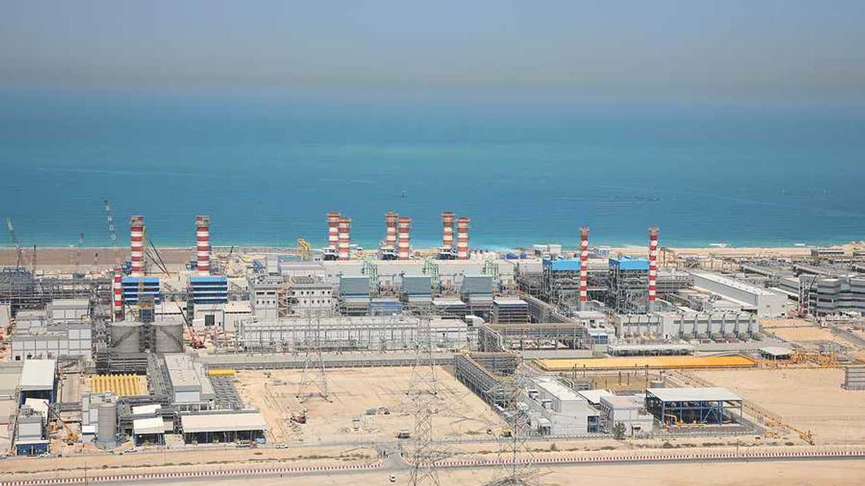 A water desalination plant in the desert next to a body of water