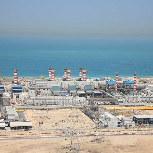 A water desalination plant in the desert next to a body of water