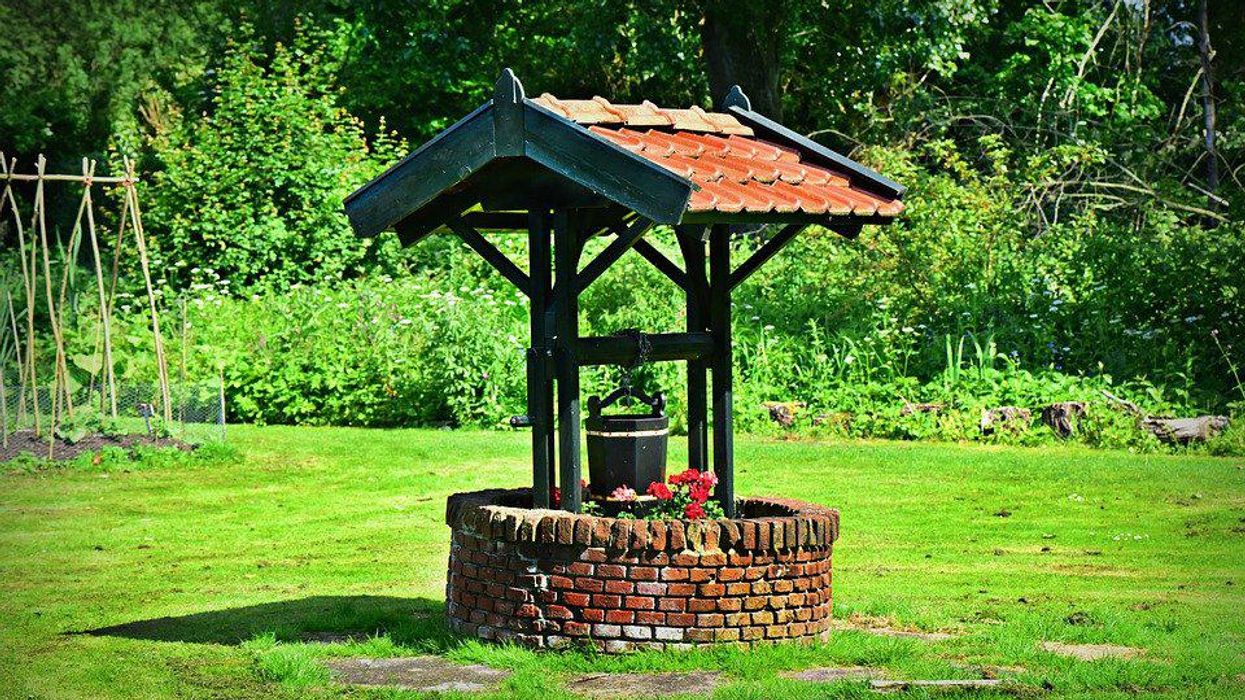 A well for groundwater in a grassy field