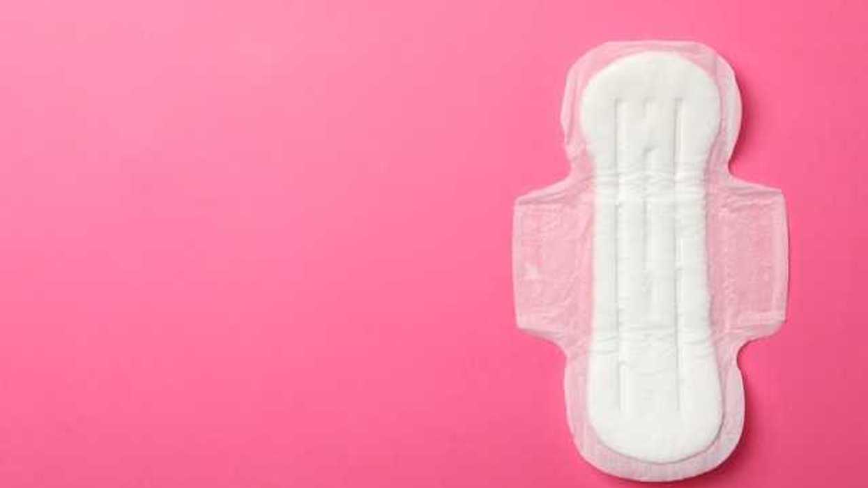 A white menstrual pad on a pink background