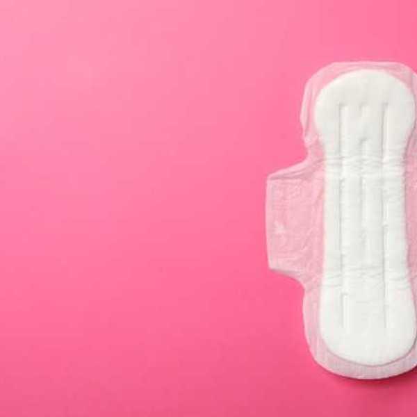 A white menstrual pad on a pink background