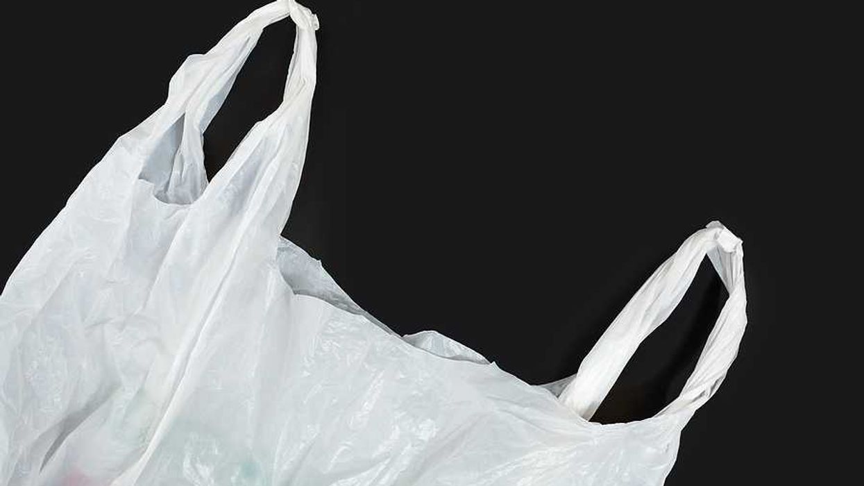 A white plastic bag against a black background