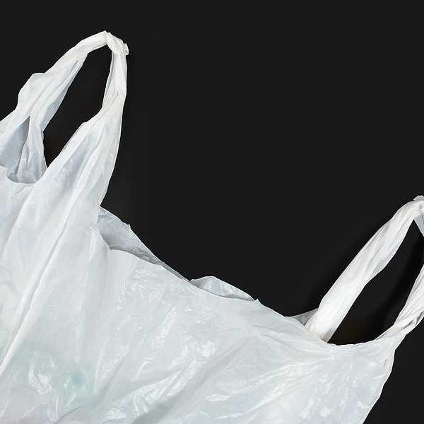 A white plastic bag against a black background