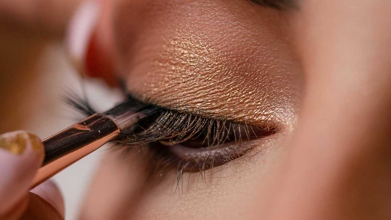a woman applying makeup done with a brush.