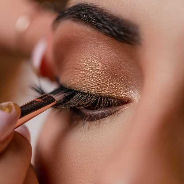 a woman applying makeup done with a brush.