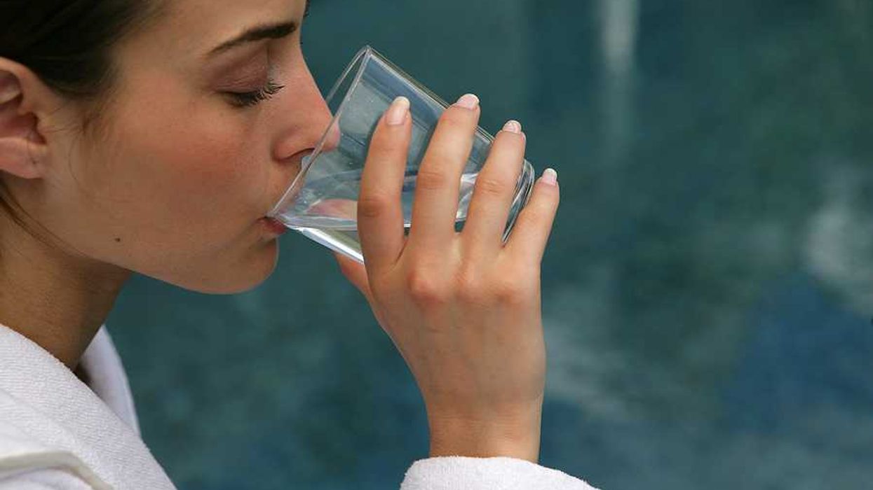 A woman drinking a glass of water