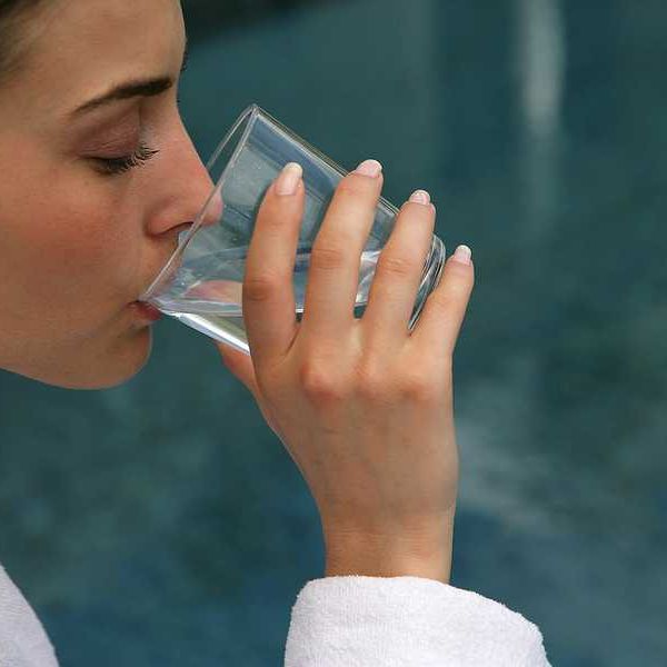 A woman drinking a glass of water