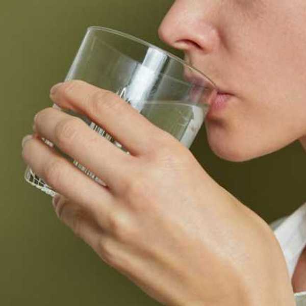 A woman drinking a glass of water