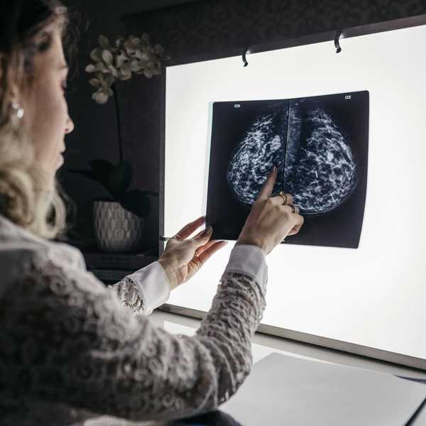A woman examines the results of a mammogram