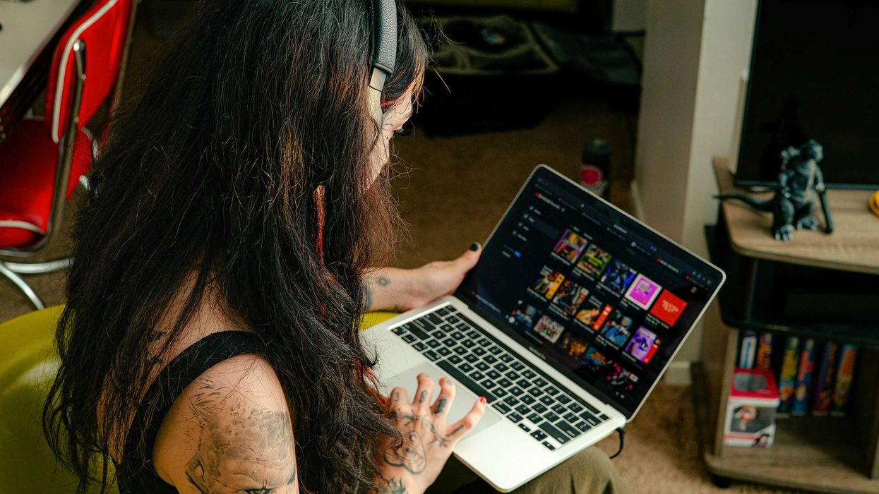 a woman sitting in a chair with a laptop