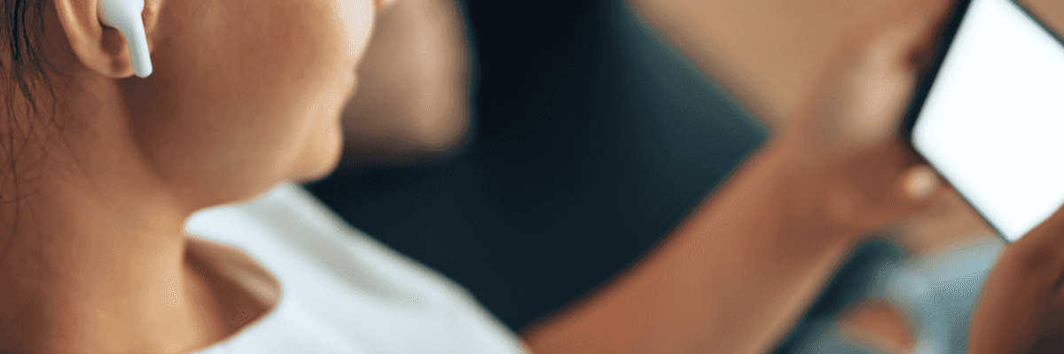 A woman wears wireless bluetooth headphones