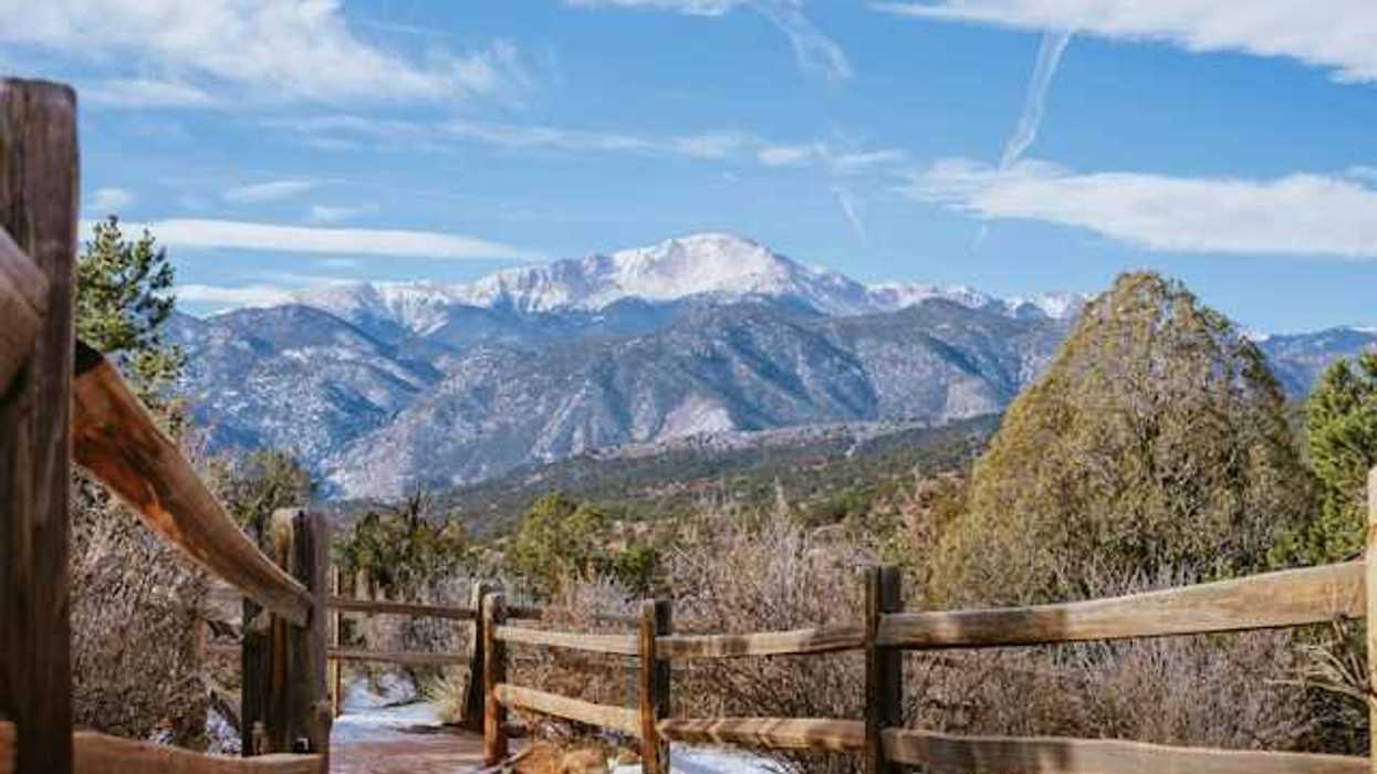 A wooden fence with a mountain view in the background