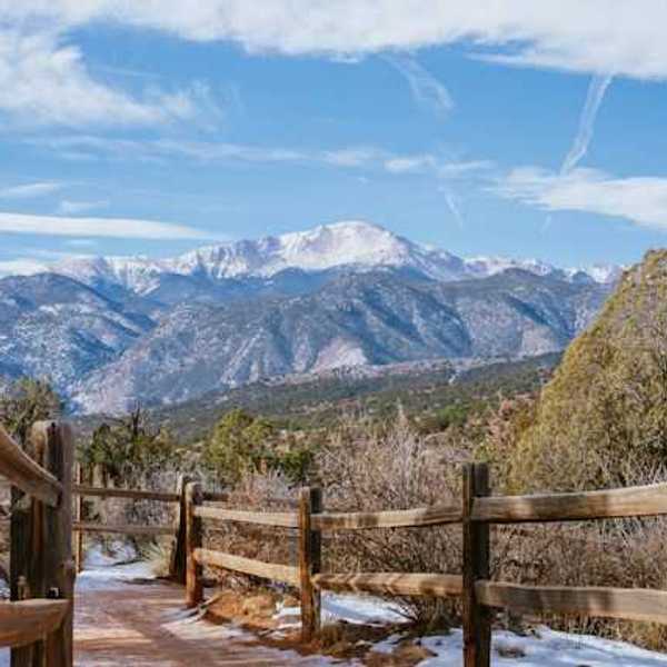 A wooden fence with a mountain view in the background