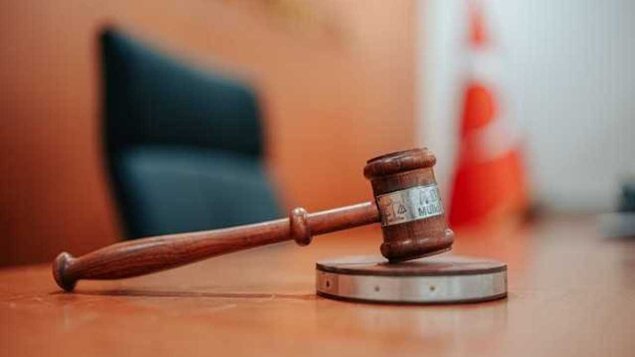 A wooden gavel on a courtroom table
