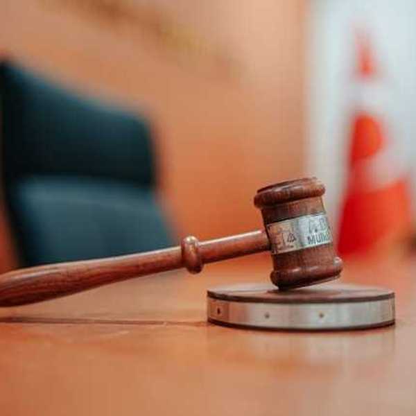 A wooden gavel on a courtroom table
