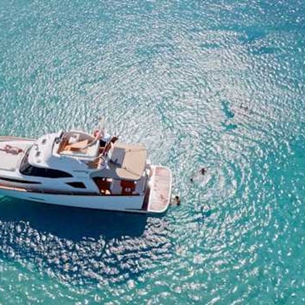 A yacht anchored in aqua blue water