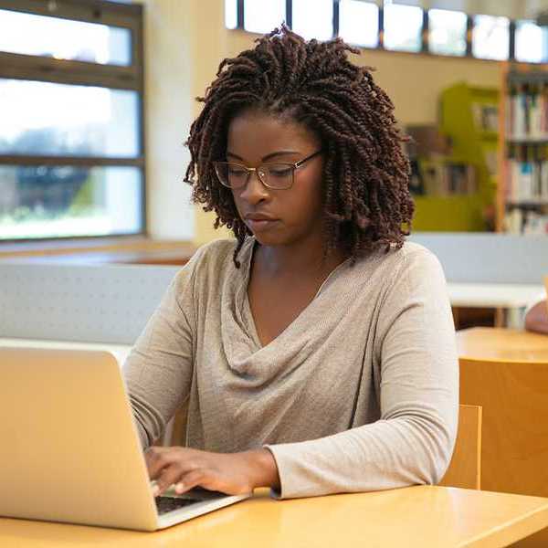 A young black woman working on a computer