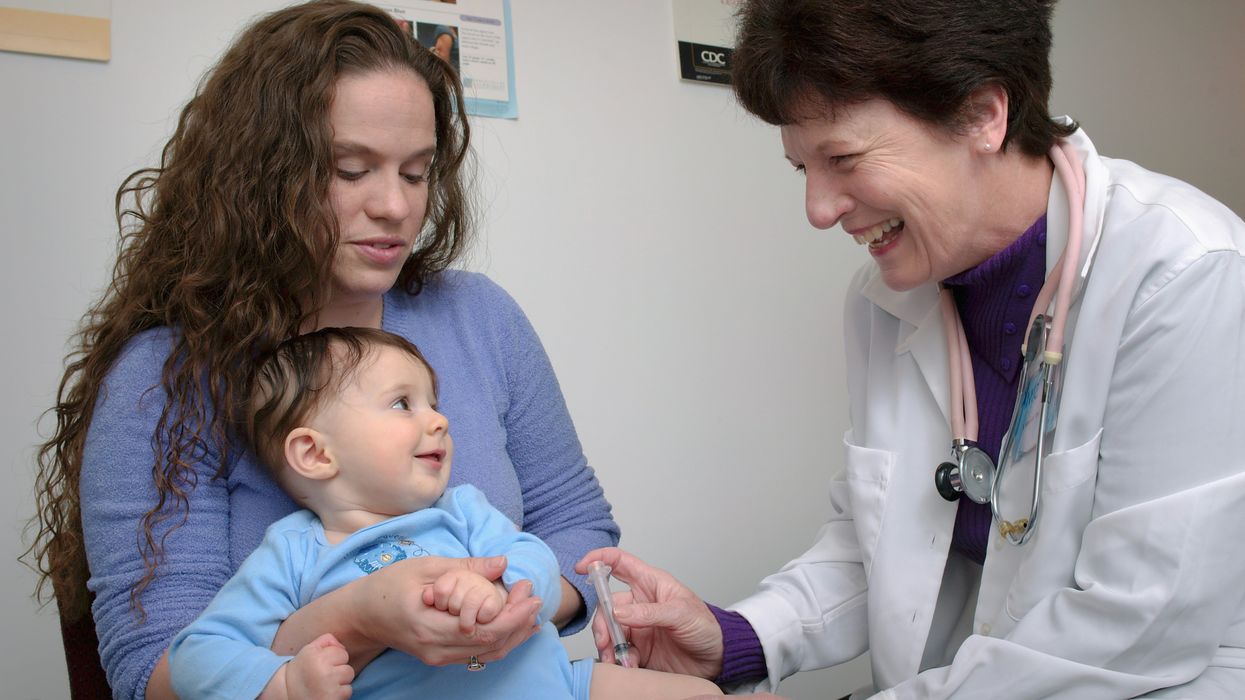 a young child being vaccinated by a doctor