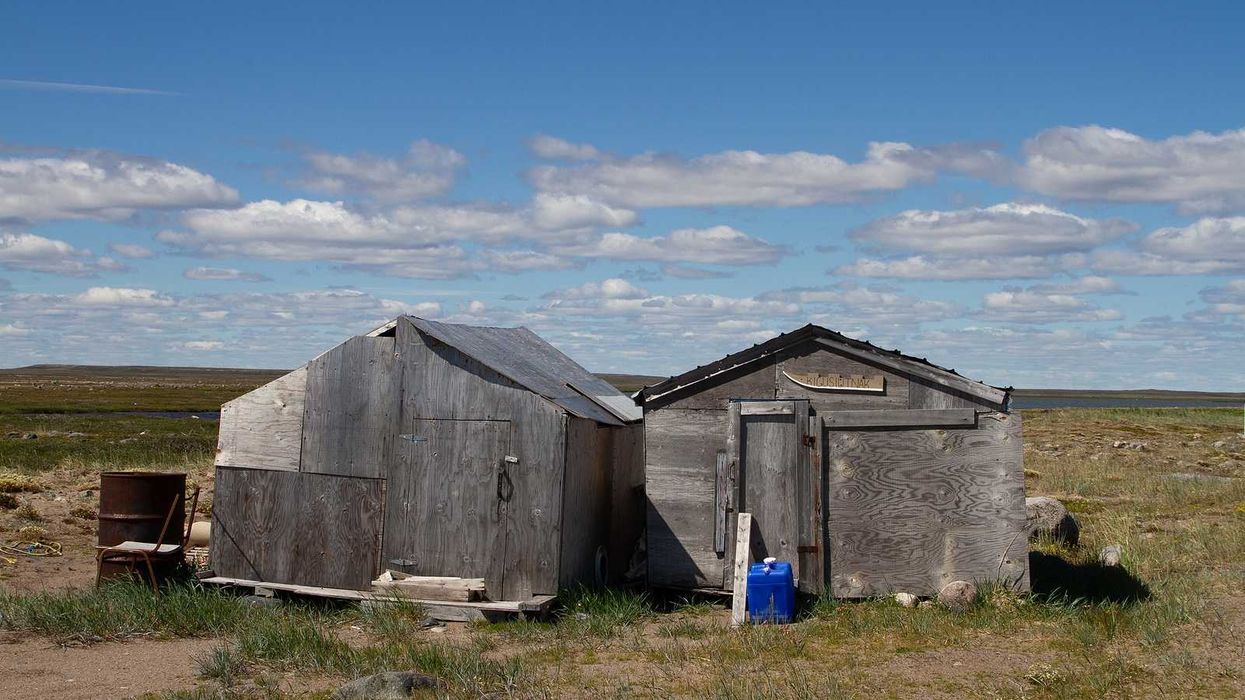 Abandoned buildings on a bare arctic summer landscape