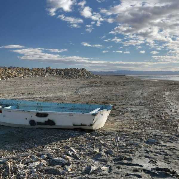Abandoned derelict rowboat beached on the shore of the Salton Sea
