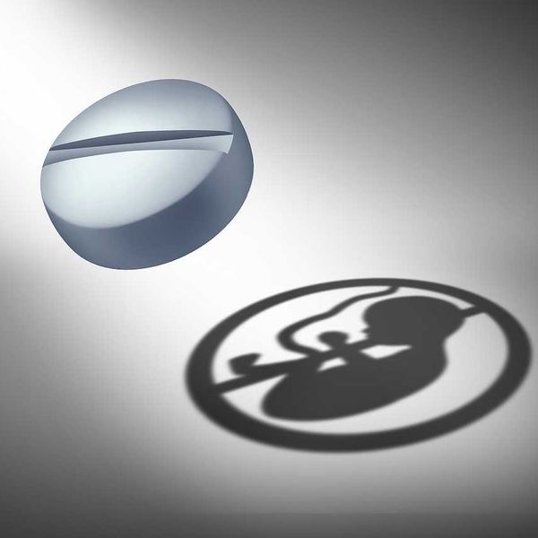 Abortion Pill Concept or oral contraceptive medication as an anti reproductive medicine to prevent pregnancy or birth control or as a social issue for reproduction justice as a 3D illustration.