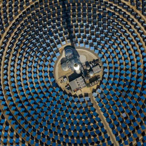 aerial view of a solar power generating facility with panels deployed in a circular configuration.